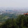 Higher up the mountain, the city can be seen amid the haze.