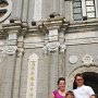 Chad, Amy, and their son Caleb in front of the old Catholic church in the district.