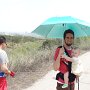 What is more intriguing? Sporting a baby or holding an umbrella on a sunny day?