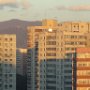 The morning sun shines brightly on apartments in Beijing.