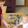 Helping Mommy take apart a puzzle.