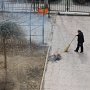 The groundskeeper for the Education Hotel burns away old branches.