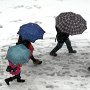 Students shelter themselves from the falling snow.