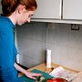 Meghan "choppin' broccoli" (garlic, actually) in our kitchen.