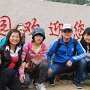 Several pose for a shot in front of the entrance to Nan Hu Park.