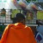 A monk stops for a refreshment.