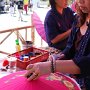 This worker paints an umbrella at the annual Bo Sang Umbrella Festival.