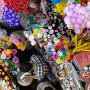 A local market sells a rainbow of flowers and other items.